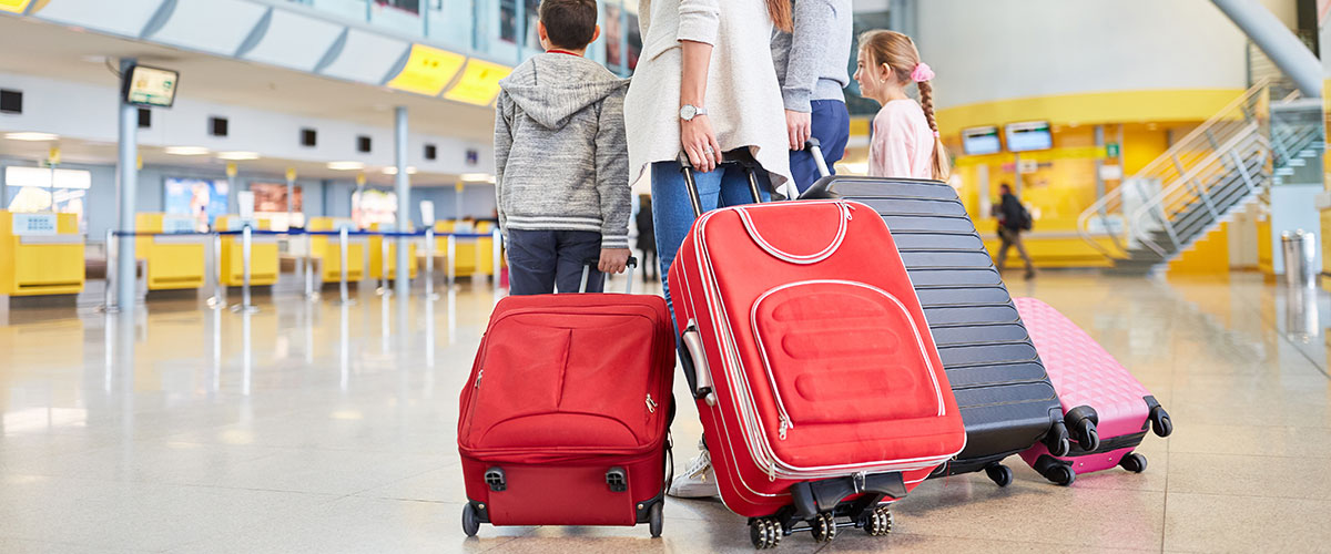 Family at airport with luggage