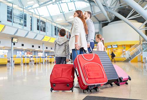 Family at airport with luggage